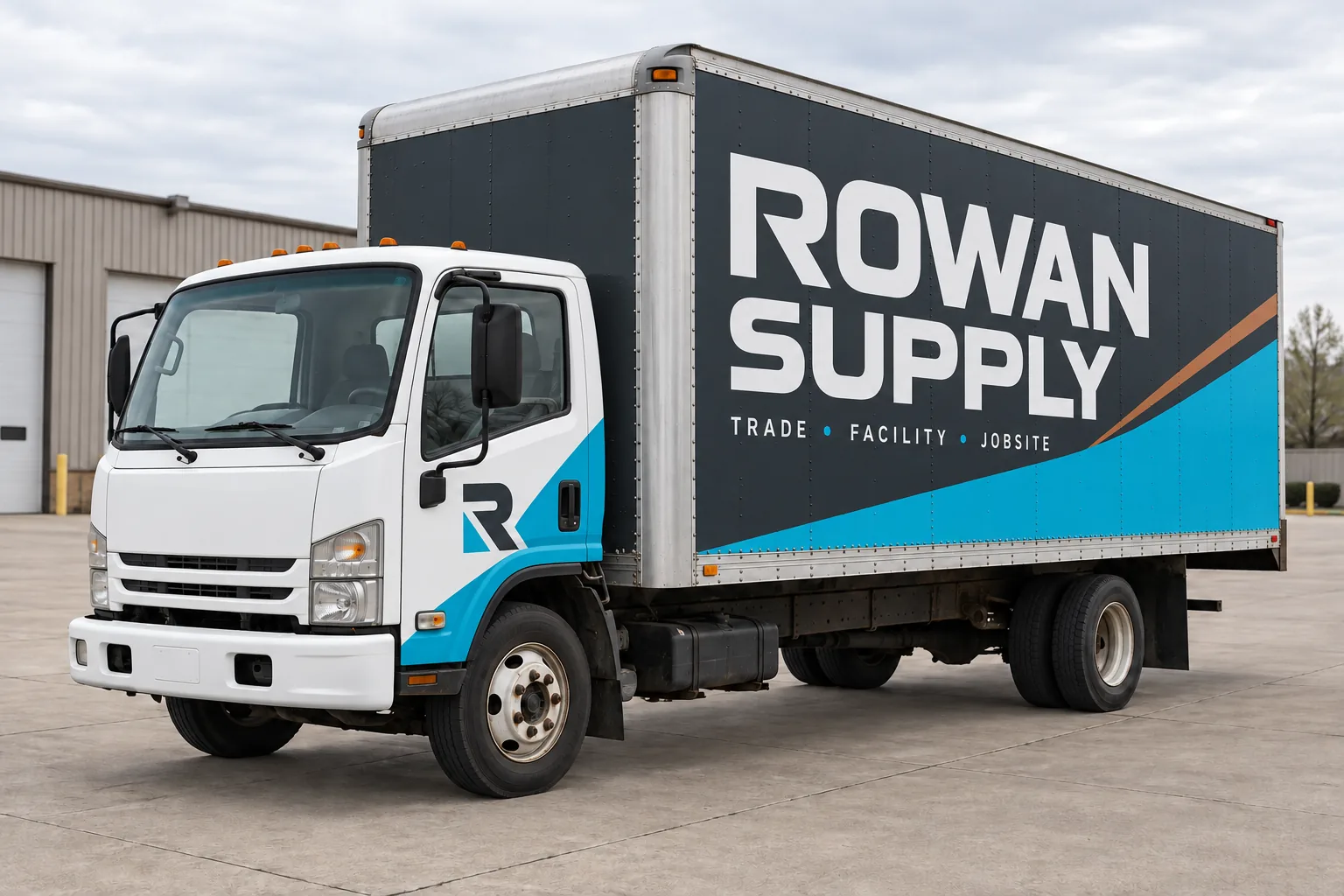 Original fictional Rowan Supply wrap concept on the same box truck, shown after separate surface preparation